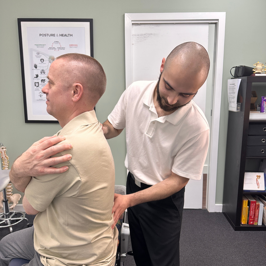 Chiropractor assessing lower back pain