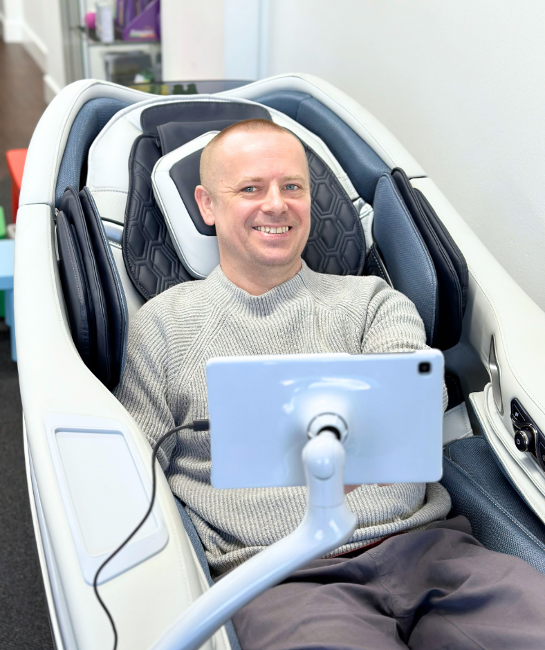 Dr Sam using Davinci massage chair