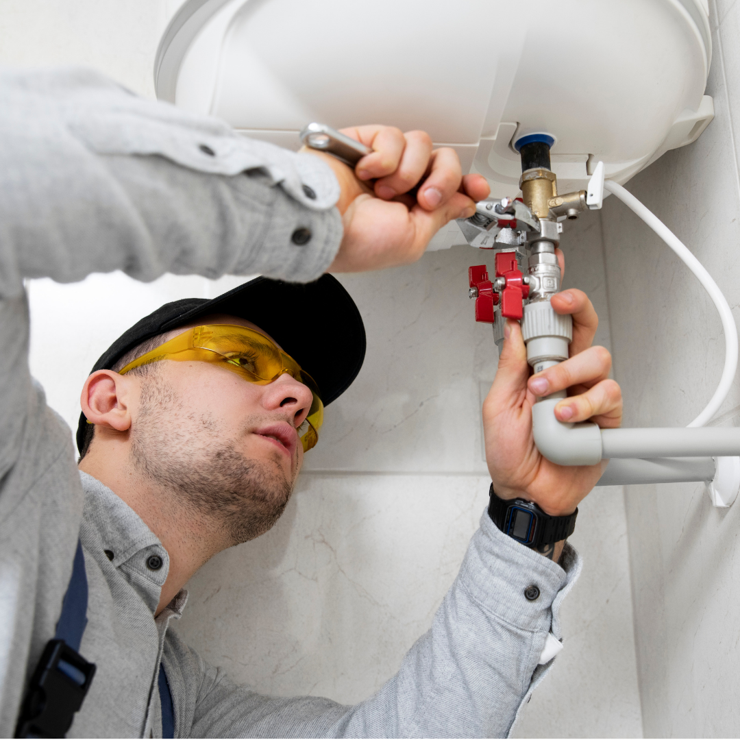 Plumber fixing pipes while putting pressure on his back